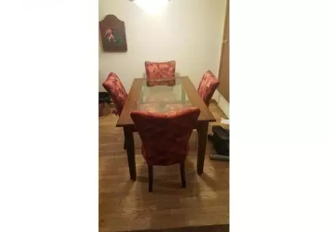 Wooden and Glass Dining Room Table with Four Upholstered Chairs